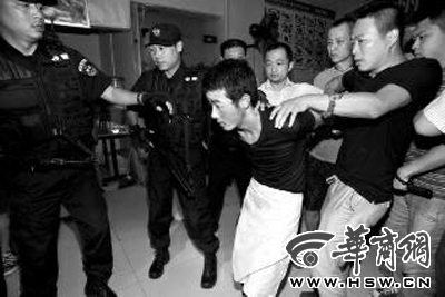 犯罪嫌疑人韓牙某圍著圍裙在廚房內拉面，被民警抓獲 本報記者 鄧小衛(wèi) 攝