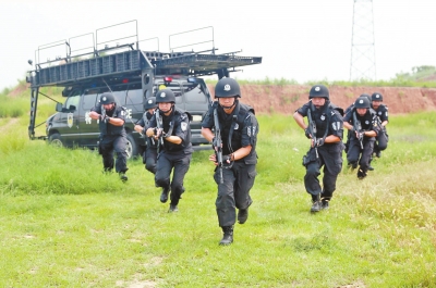 在拍攝現(xiàn)場，特警隊(duì)員下車后快速出擊。記者張琮攝影